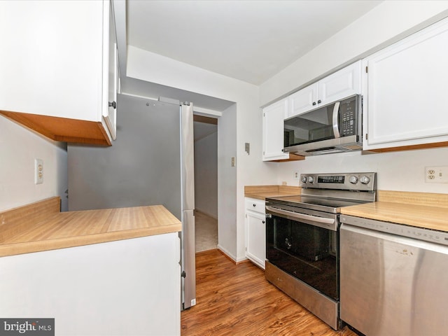 kitchen featuring white cabinets, light wood-type flooring, and appliances with stainless steel finishes