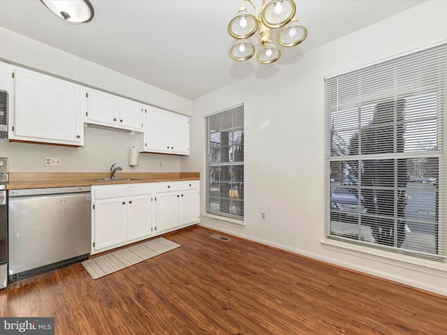 kitchen with dishwasher, dark hardwood / wood-style floors, white cabinetry, and sink