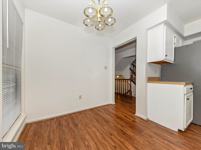 interior space with a chandelier and hardwood / wood-style floors