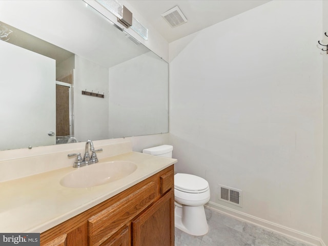 bathroom featuring vanity, toilet, and an enclosed shower