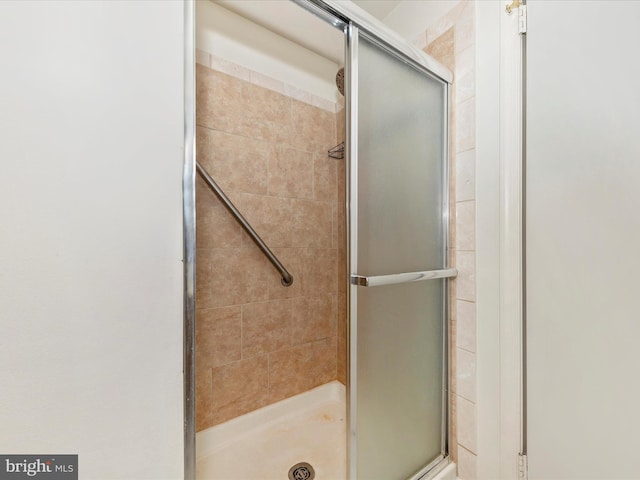 bathroom with a shower with shower door