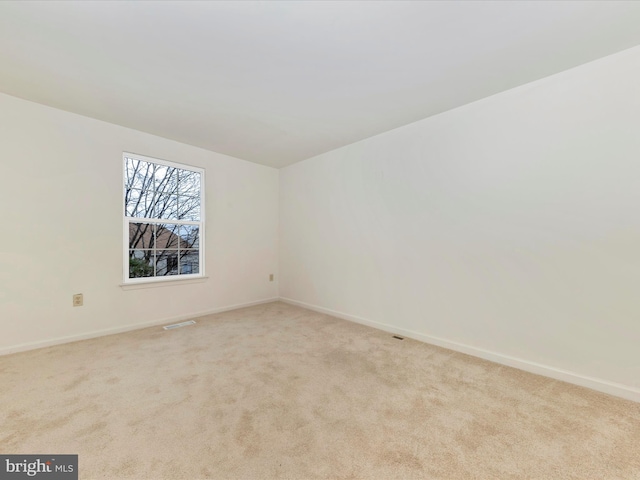 unfurnished room with light carpet