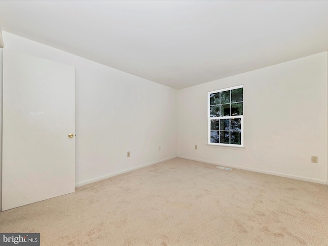 empty room featuring light carpet