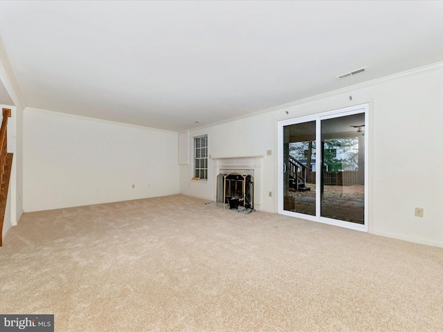 unfurnished living room featuring ornamental molding and light carpet