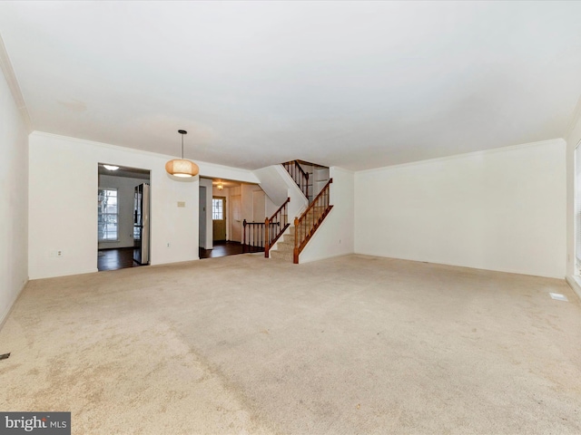 unfurnished living room with crown molding and carpet floors