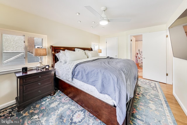 bedroom with ceiling fan and light hardwood / wood-style floors