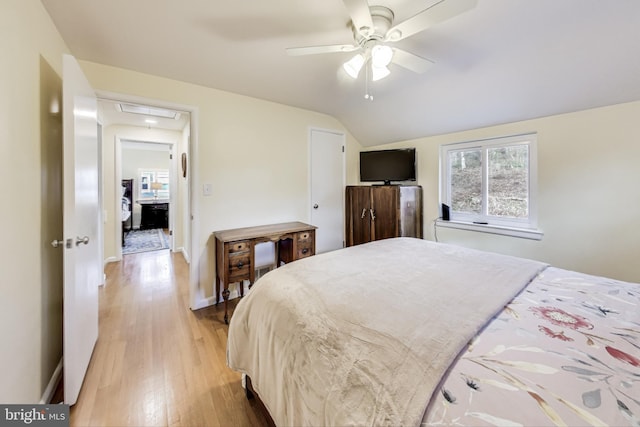 bedroom featuring vaulted ceiling, ceiling fan, and light hardwood / wood-style floors