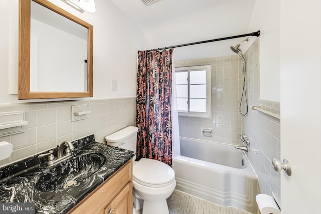 full bathroom with tile walls, toilet, shower / bath combo, and vanity