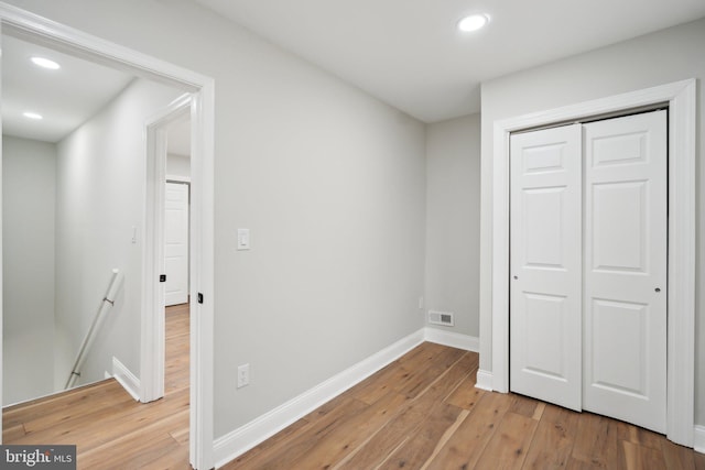 interior space with a closet and light hardwood / wood-style flooring