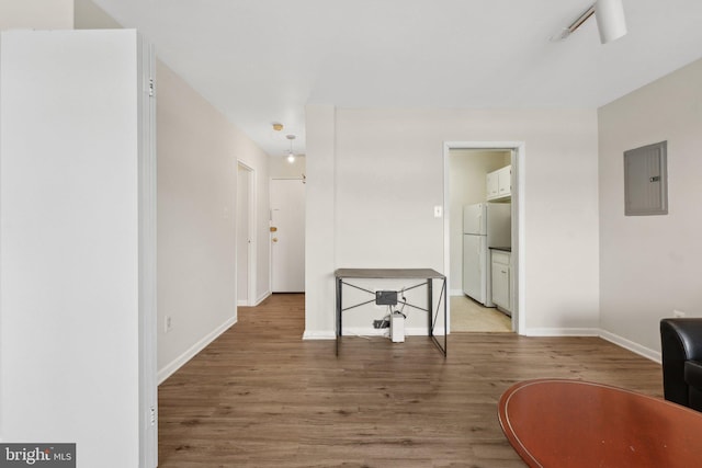 corridor featuring electric panel and hardwood / wood-style floors