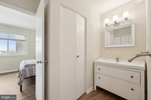 bathroom with hardwood / wood-style floors and vanity