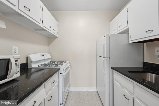 kitchen featuring white cabinets and white appliances