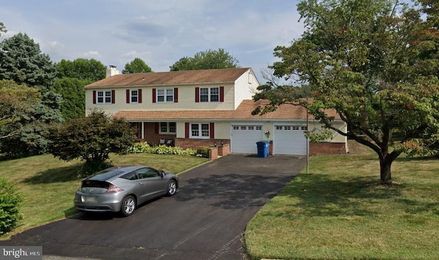 view of front of home with a front yard and a garage