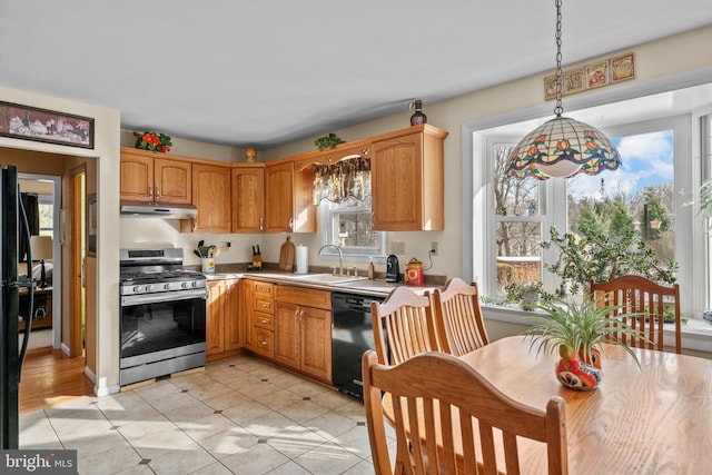 kitchen with stainless steel range with gas stovetop, hanging light fixtures, plenty of natural light, sink, and black dishwasher