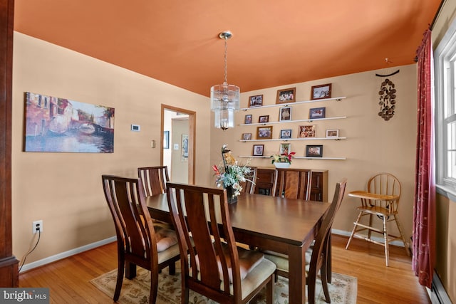 dining room featuring baseboard heating and light hardwood / wood-style flooring