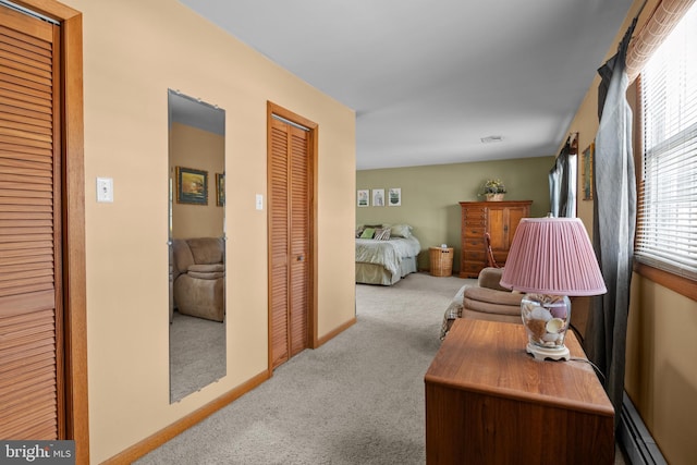 hall featuring baseboard heating and light colored carpet