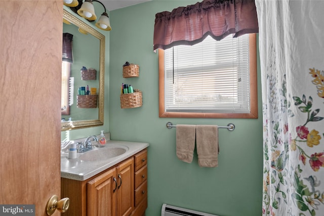 bathroom with walk in shower, vanity, and a baseboard heating unit