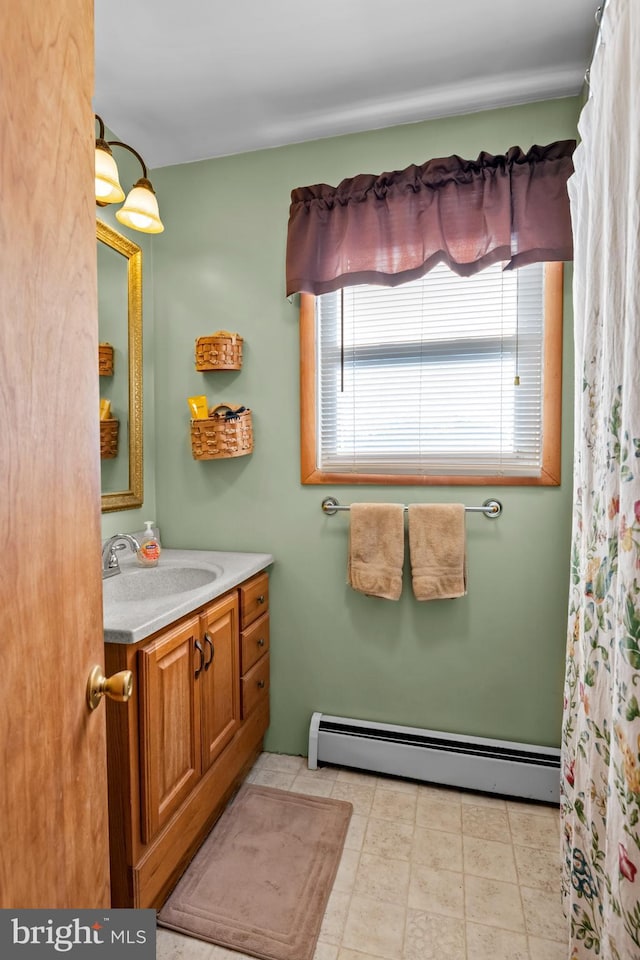 bathroom with baseboard heating and vanity