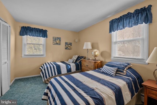 carpeted bedroom featuring a closet and baseboard heating