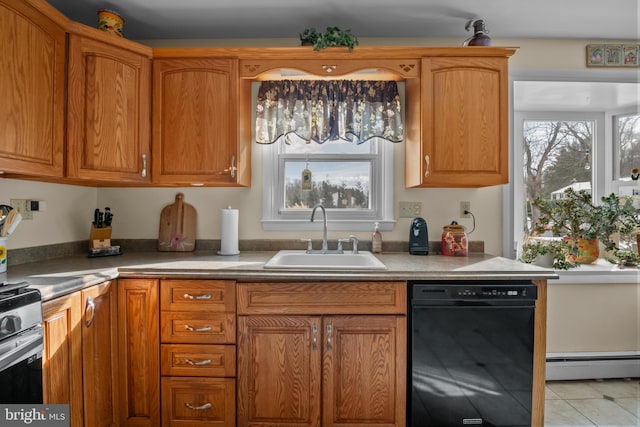 kitchen featuring sink, baseboard heating, plenty of natural light, and black dishwasher