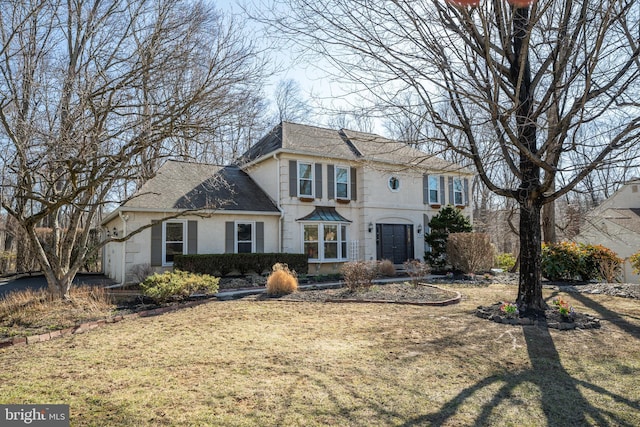 view of front of property with stucco siding and a shingled roof