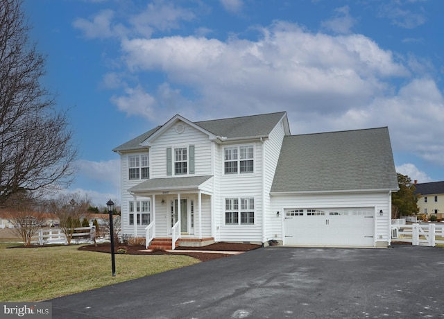 front of property featuring a garage and a front lawn