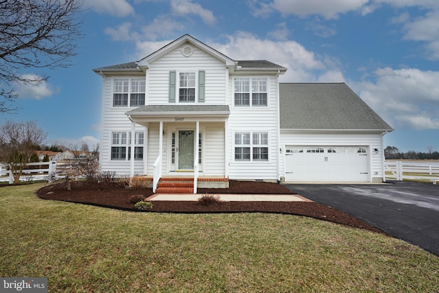 view of front of home featuring a garage and a front yard