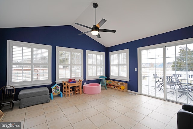 rec room featuring light tile patterned flooring, lofted ceiling, a healthy amount of sunlight, and ceiling fan