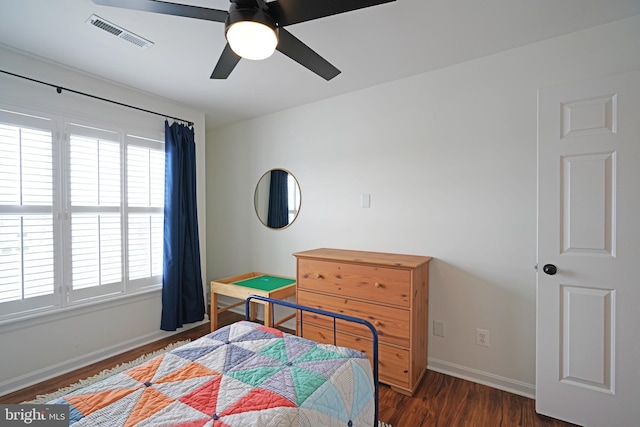 bedroom with ceiling fan, dark hardwood / wood-style flooring, and multiple windows