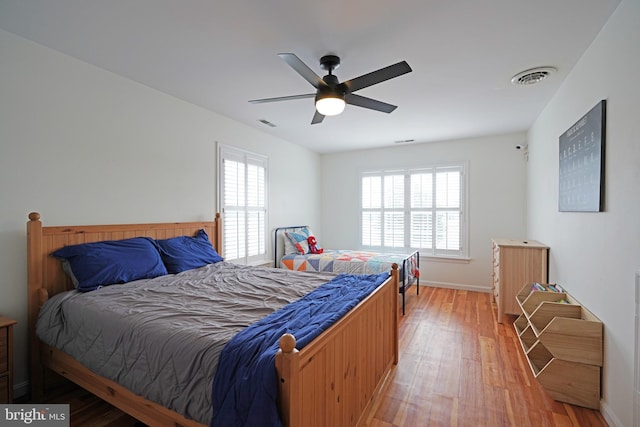 bedroom with hardwood / wood-style flooring and ceiling fan