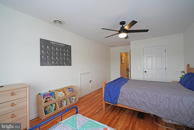 bedroom with ceiling fan and wood-type flooring