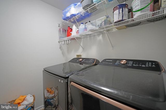 clothes washing area featuring washer and clothes dryer