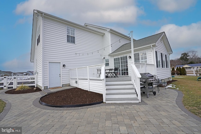 back of house featuring a patio area and a deck