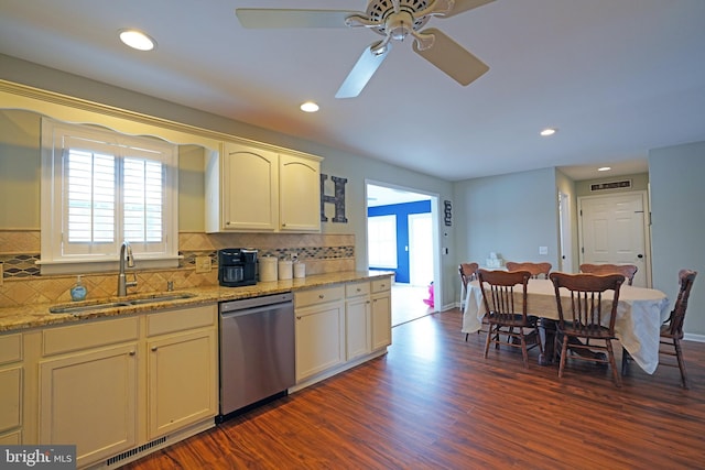 kitchen with tasteful backsplash, sink, dark hardwood / wood-style flooring, stainless steel dishwasher, and light stone counters