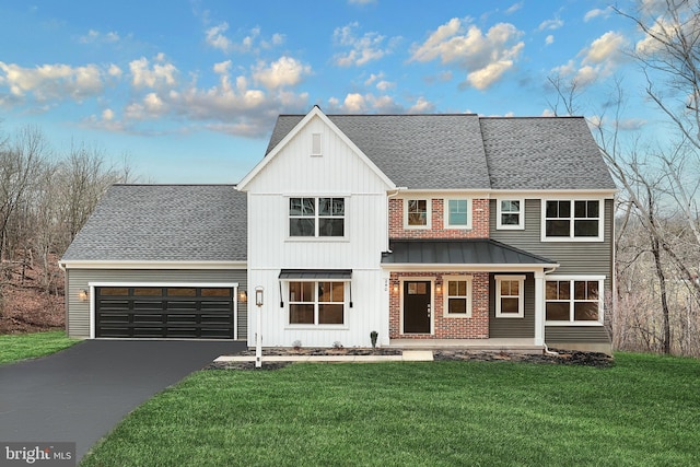 view of front facade with a front yard, a garage, and covered porch