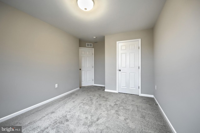 unfurnished bedroom featuring light carpet