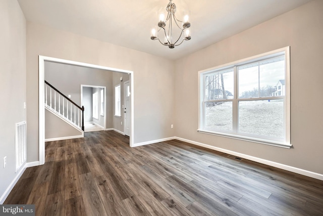 unfurnished dining area with a chandelier, dark hardwood / wood-style floors, and plenty of natural light