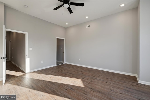 unfurnished room featuring ceiling fan and dark wood-type flooring