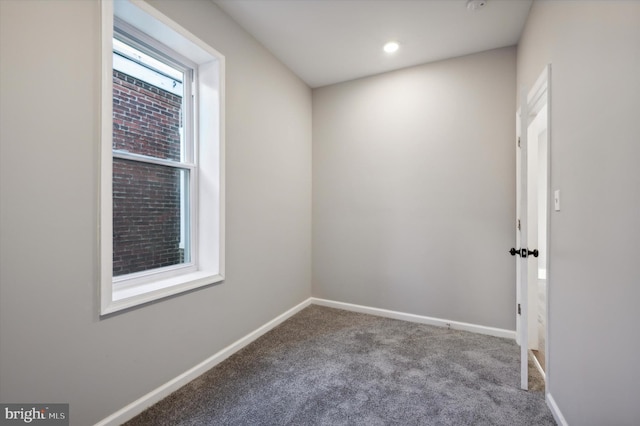 spare room featuring light colored carpet