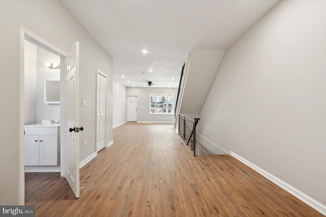 corridor featuring light hardwood / wood-style flooring and sink