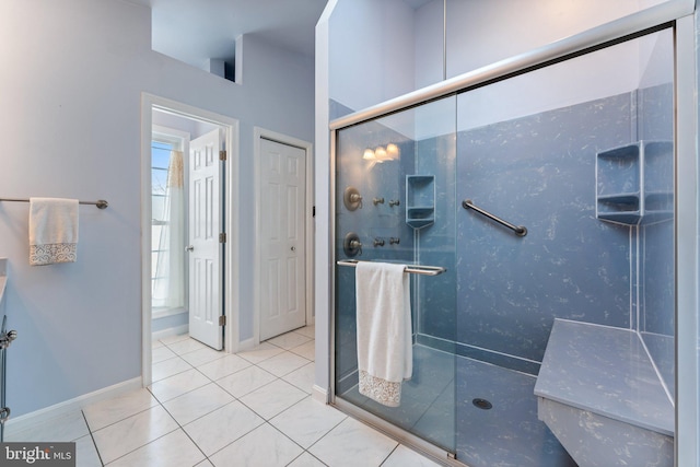 bathroom with tile patterned flooring and an enclosed shower