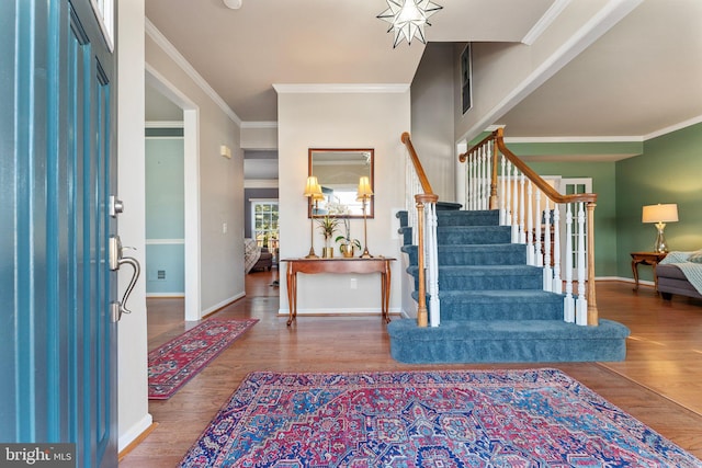 entryway featuring hardwood / wood-style flooring and ornamental molding