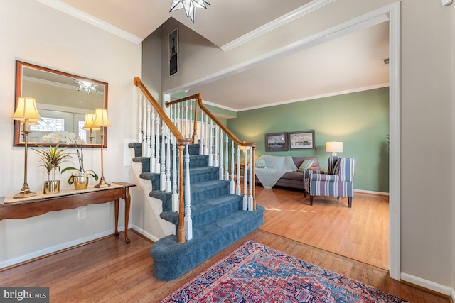 staircase with crown molding and hardwood / wood-style flooring