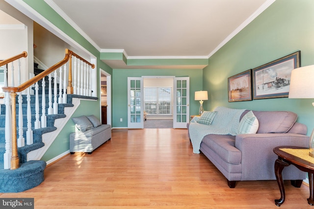 living room with crown molding and light hardwood / wood-style flooring