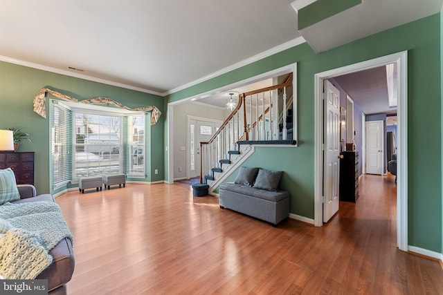 living room featuring hardwood / wood-style floors and ornamental molding