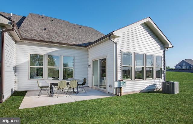 rear view of house with a yard, cooling unit, and a patio area