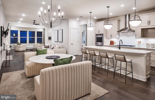 dining room featuring sink, a chandelier, and dark hardwood / wood-style floors