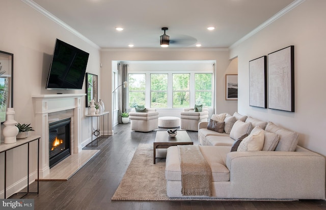 living room featuring ceiling fan, a fireplace, dark hardwood / wood-style floors, and ornamental molding