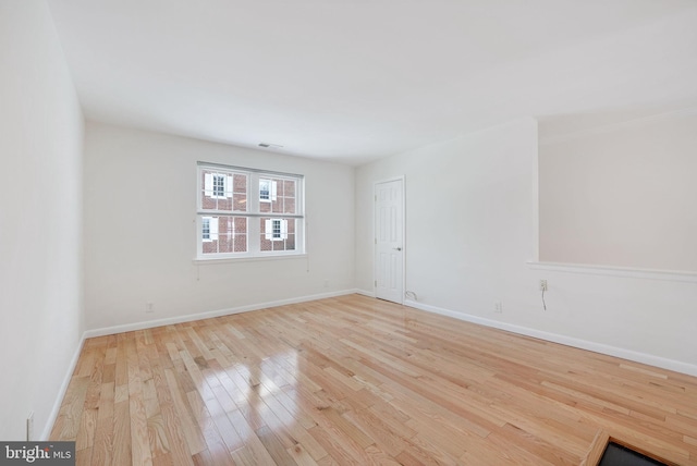 unfurnished room with light hardwood / wood-style flooring