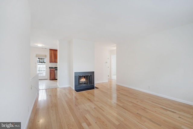 unfurnished living room with light wood-type flooring